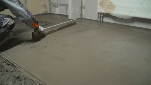 Using different leveling tools to level wet concrete