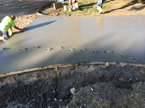 Wet concrete for a driveway. Removing footprints